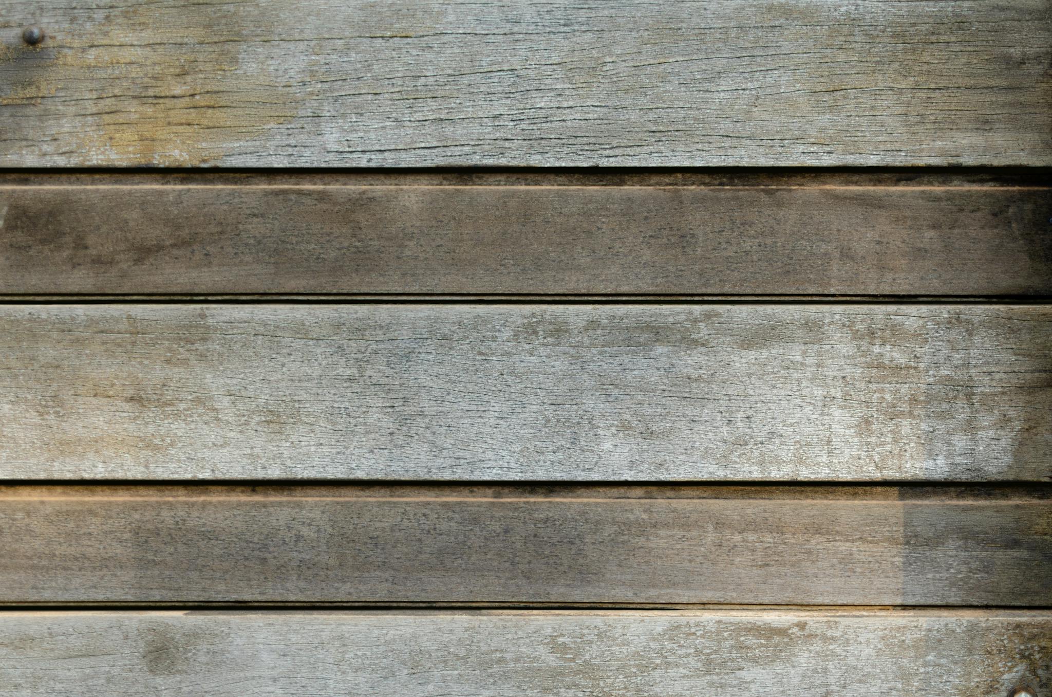 A close-up view of a rustic wooden panel texture, ideal for backgrounds and design projects.